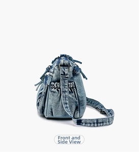 Detail view of washed denim crossbody bag featuring multiple pockets and drawstring sides
