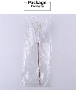 Detailed view of artificial white calla lily flower in clear plastic packaging