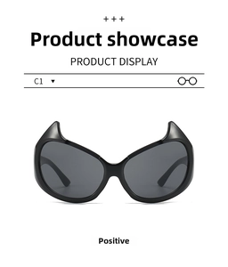 Front view of black devil horn sunglasses with dark grey lenses and a glossy resin frame