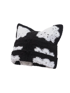 Detail of handmade knit cat ear beanie with black and white stripes texture