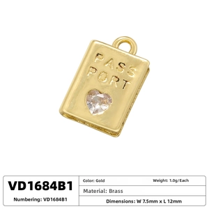 Detailed macro of a 7.5x12mm brass passport charm with a heart-shaped zircon inlay