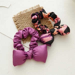 Elastic Christmas scrunchie set with purple satin and orange-black patterned bow design