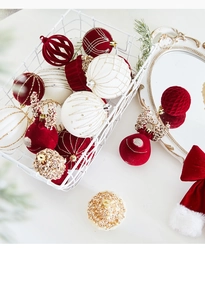 Detail of champagne gold flocked Christmas baubles and reindeer decor in a gift basket