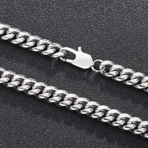 Close-up of silver Cuban link chain showing polished metal texture and secure lobster clasp