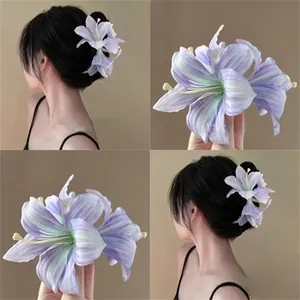 Detailed view of handmade light purple lily flower hair clip with realistic fabric petals