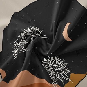 Detail showing the soft texture and bohemian pattern of the black celestial tapestry