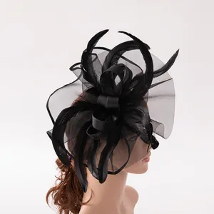 Elegant black feather fascinator hat with mesh veil and bow for wedding or cocktail party