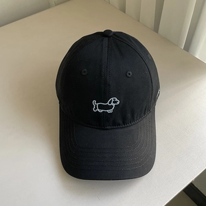 Close-up of cute sausage dog embroidery on a premium black cotton baseball cap