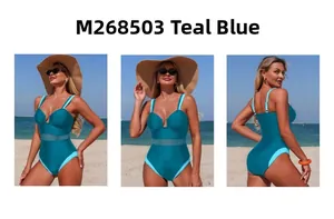 Three-view display of teal one-piece swimsuit with mesh paneling on a sunny beach