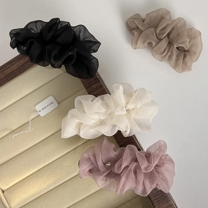 Elegant chiffon scrunchies set in black beige white and purple on velvet display