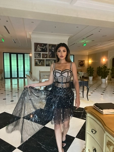 Close-up of black sequined mesh dress with slim-fit bodice and sparkling details