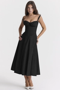 Detail of elegant black corset style midi dress with delicate spaghetti straps