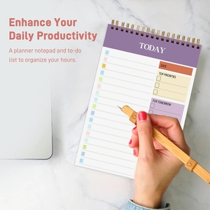 Detailed view of purple daily planner notebook featuring wire-o binding and task sections