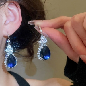 Elegant water drop earrings set with deep blue pear-cut stones and zircon floral accents