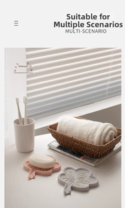 Pink and grey floral silicone soap holders with drainage holes in a bathroom setting