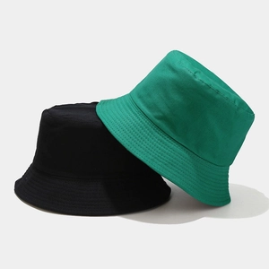 Detail of black and forest green cotton canvas bucket hats with reinforced brim stitching