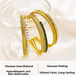 Detailed macro view of gold titanium steel bracelets with pearls and zircons
