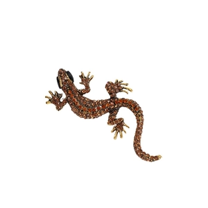 Vintage gecko lizard brooch featuring amber rhinestones on an antique gold metal base
