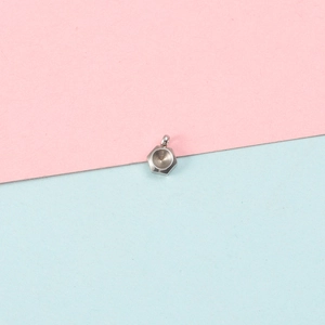 Close-up of hexagonal stainless steel pendant base with textured inner surface
