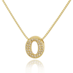 Macro shot of gold pendant with letter O and pavé set cubic zirconia on a box chain necklace