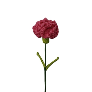 Handmade pink crochet carnation flower with green leaves on white background
