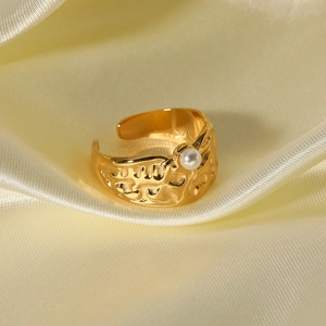 Lava textured 18k gold plated open ring with white pearl on yellow silk background