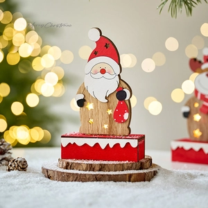Wooden LED Santa Claus ornament with warm lights on a rustic tree base for Christmas decor