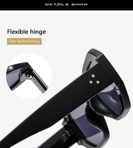 Detail view of flexible metal hinges and silver rivets on black polygon sunglasses