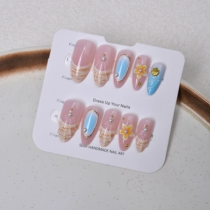 Macro detail of almond nails with 3D ocean shells, pearls, and pink blue gradient finish
