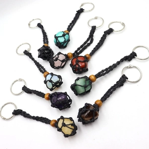 Detailed view of assorted natural stone keychains with handmade black mesh weaving
