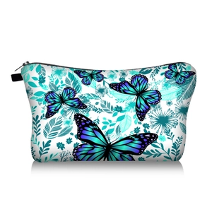 Detail of the butterfly and floral print on white travel toiletry bag with black zipper