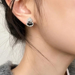 Zircon crystal gourd stud earring with black stone and silver finish on a model