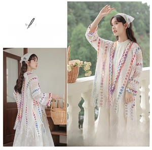 Dettaglio del cardigan bianco all'uncinetto con bordi colorati smerlati in stile bohémien