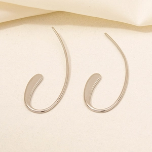 Detailed view of silver 304 stainless steel earrings on a soft minimalist background