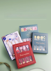 Close-up of assorted stainless steel dessert spoons and forks with cute cartoon charms