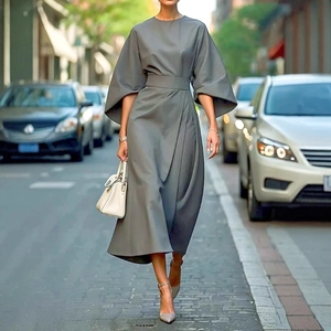 Elegant grey maxi dress with batwing sleeves and belted waist in street style view