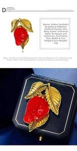 Detail view of the red synthetic strawberry brooch with dimensions 4.7cm by 6.6cm