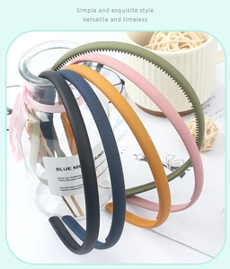 Close-up of matte Morandi headbands with non-slip teeth on a glass bottle display