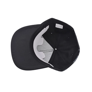 Detail view of the black baseball cap showing the 100% cotton material and care label