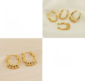 Detail of 18K gold plated hoop earrings with pearls and zircon stones on linen fabric