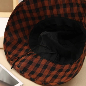 Detail view of plaid sun hat showing inner black lining and adjustable drawstring