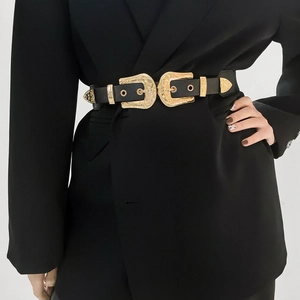Detail of vintage Y2K belt with double gold buckles on a black blazer jacket