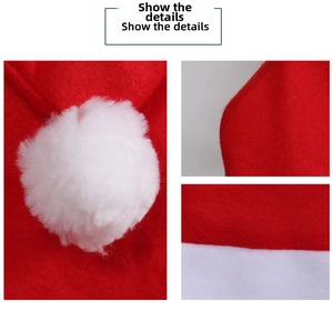 Detail view of red velvet Christmas chair cover fabric and white plush pom-pom texture