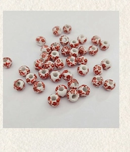 Detail of 10mm white ceramic beads with red plum flower patterns for DIY jewelry