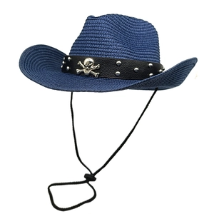 Detail of dark blue straw cowboy hat with skull rivets and adjustable wind strap