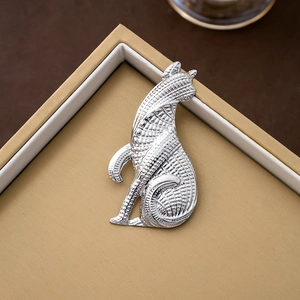 Vintage silver cat brooch with minimalist design on a premium gift box cover