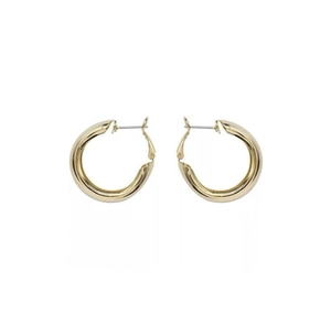 Close-up of thick gold-plated hoop earrings featuring a smooth, polished geometric C-shape
