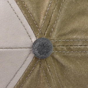 Close-up of top button and dual-color washed cotton twill stitching on the baseball cap