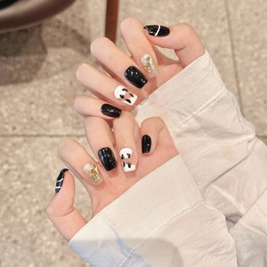 Handmade press-on nails set featuring black, cow print and gold glitter square-oval design