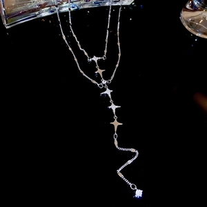 Detail of silver double-layer star pendant necklace with cubic zirconia tassels